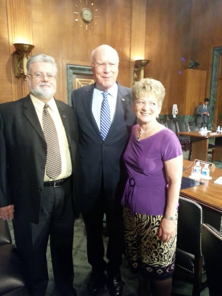 Senator Patrick Leahy stands with the law's namesake, survivor Debbie Smith and her husband Rob.