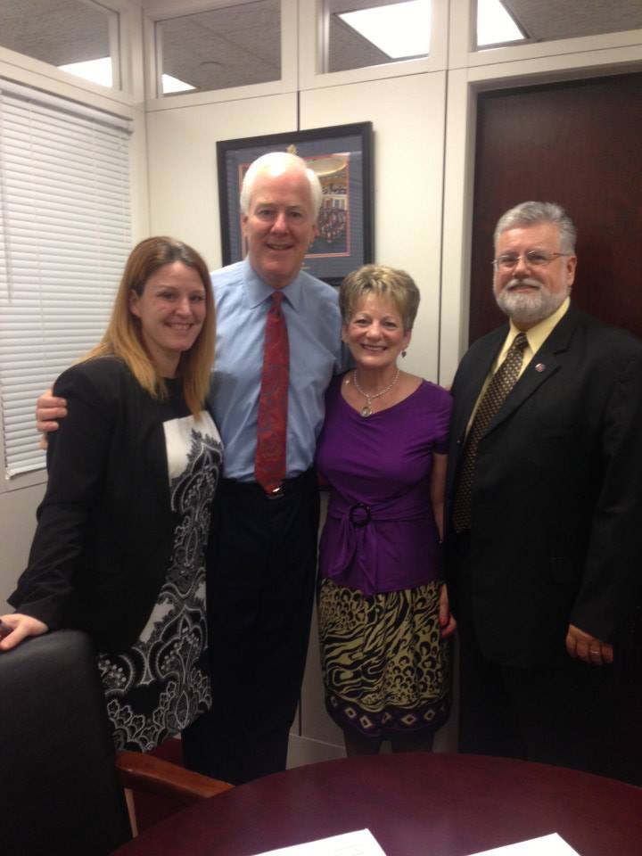 From left Rebecca O'Connor, VP of Public Policy for RAINN and Senator John Cornyn stand with the law's namesake, survivor Debbie Smith and her husband Rob.