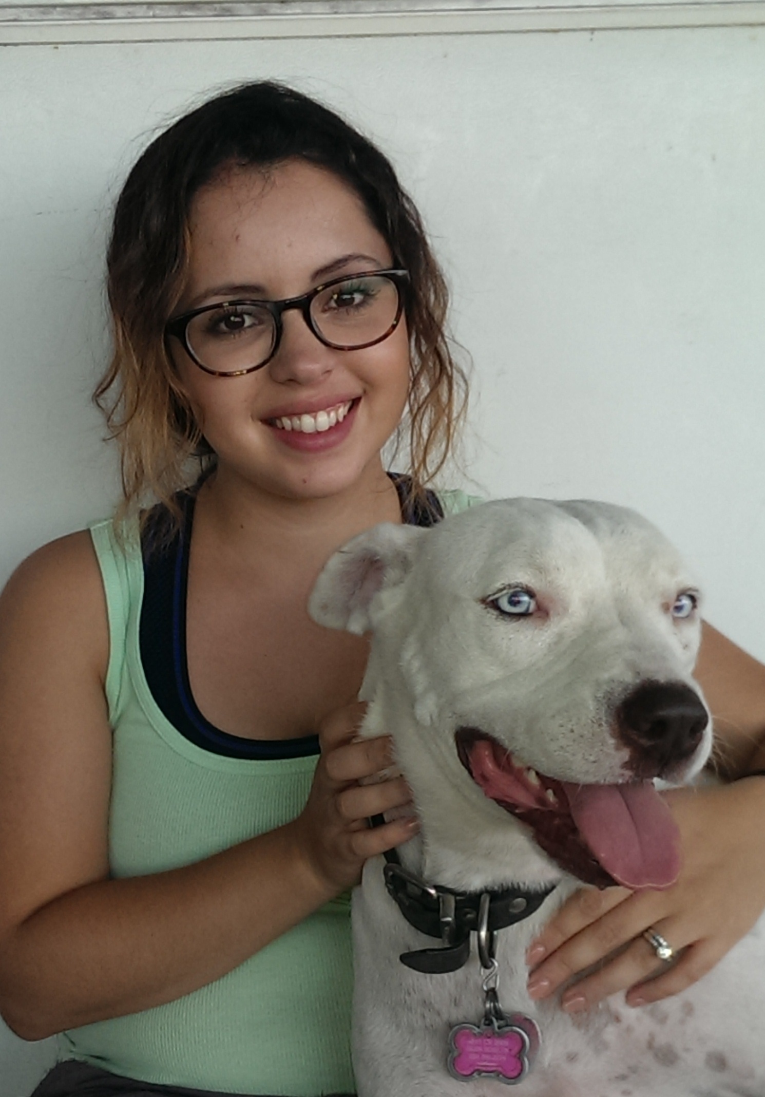 Sexual assault survivor Adriana holds her rescue dog Milli.
