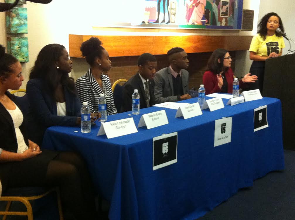 Panelists sit at a table during an event about sexual assault on campus