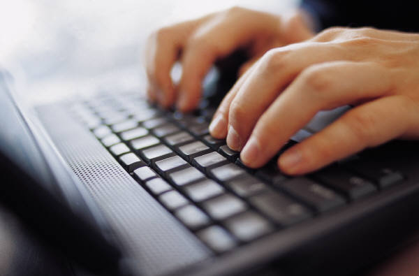 Hands typing on a keyboard