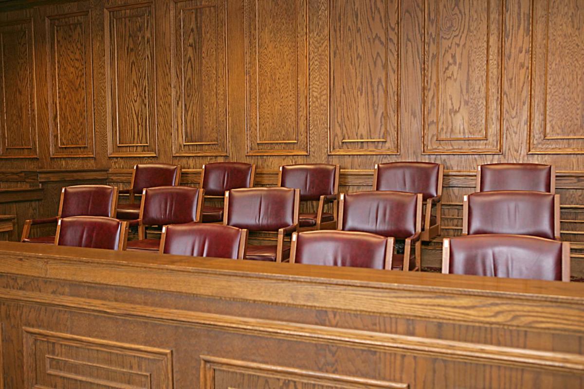 An empty juror's box in a courtroom.